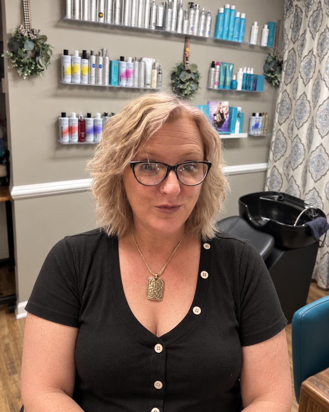 Amy, cosmetologist and esthetician at Stepping Out Beautiful, in her salon room