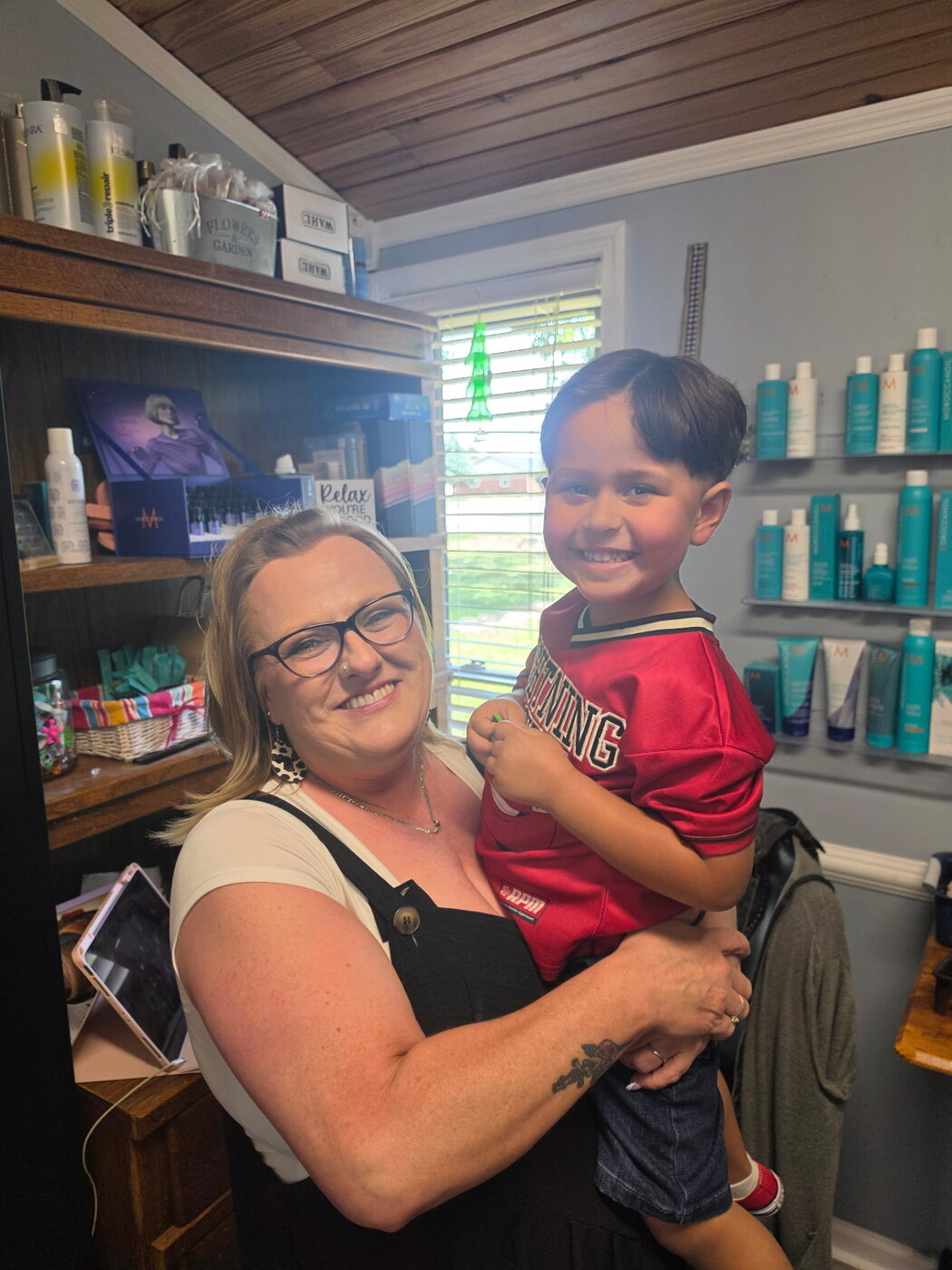 Amy with a happy young client after his haircut