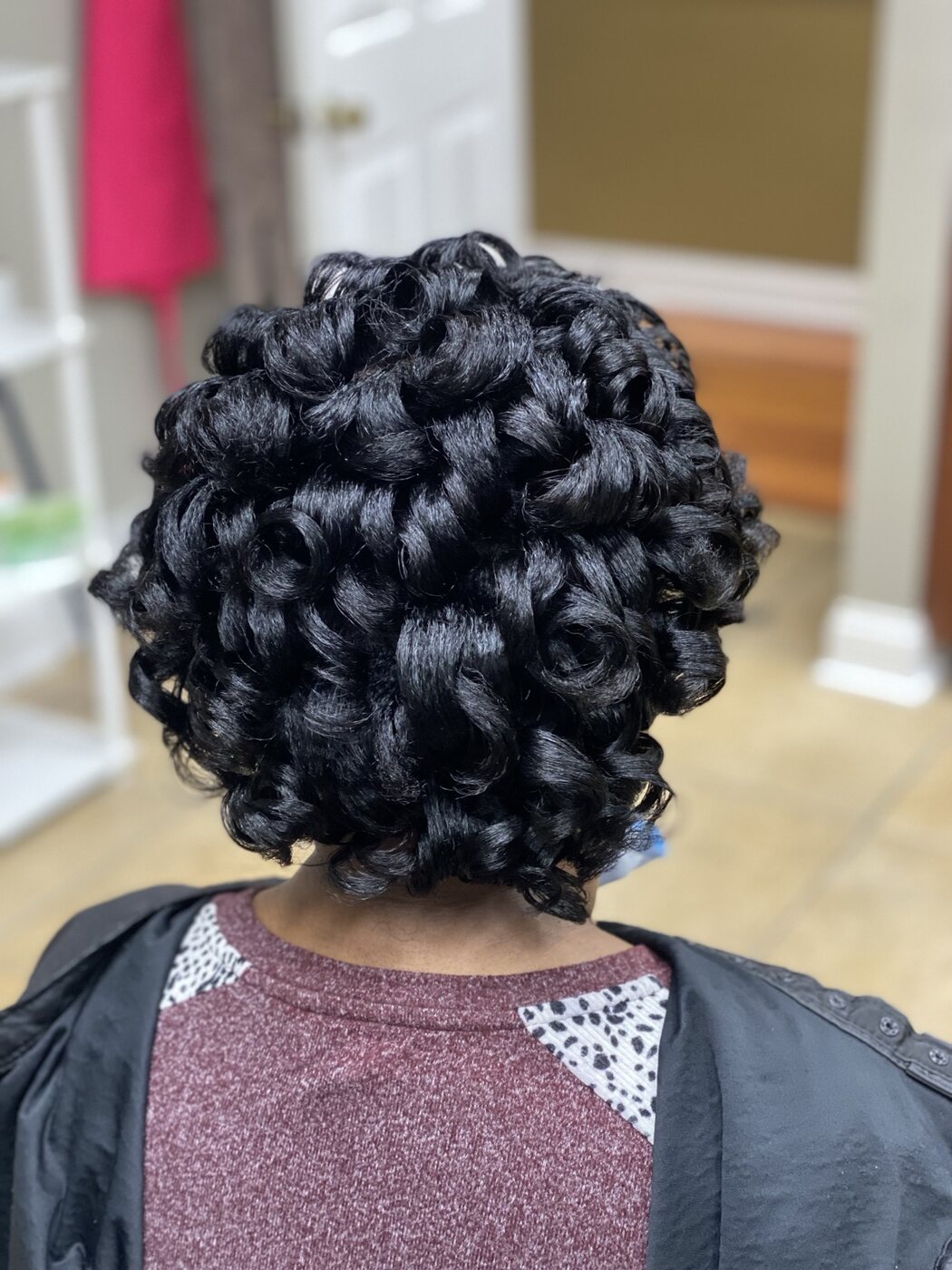 Glossy black curl set viewed from the back
