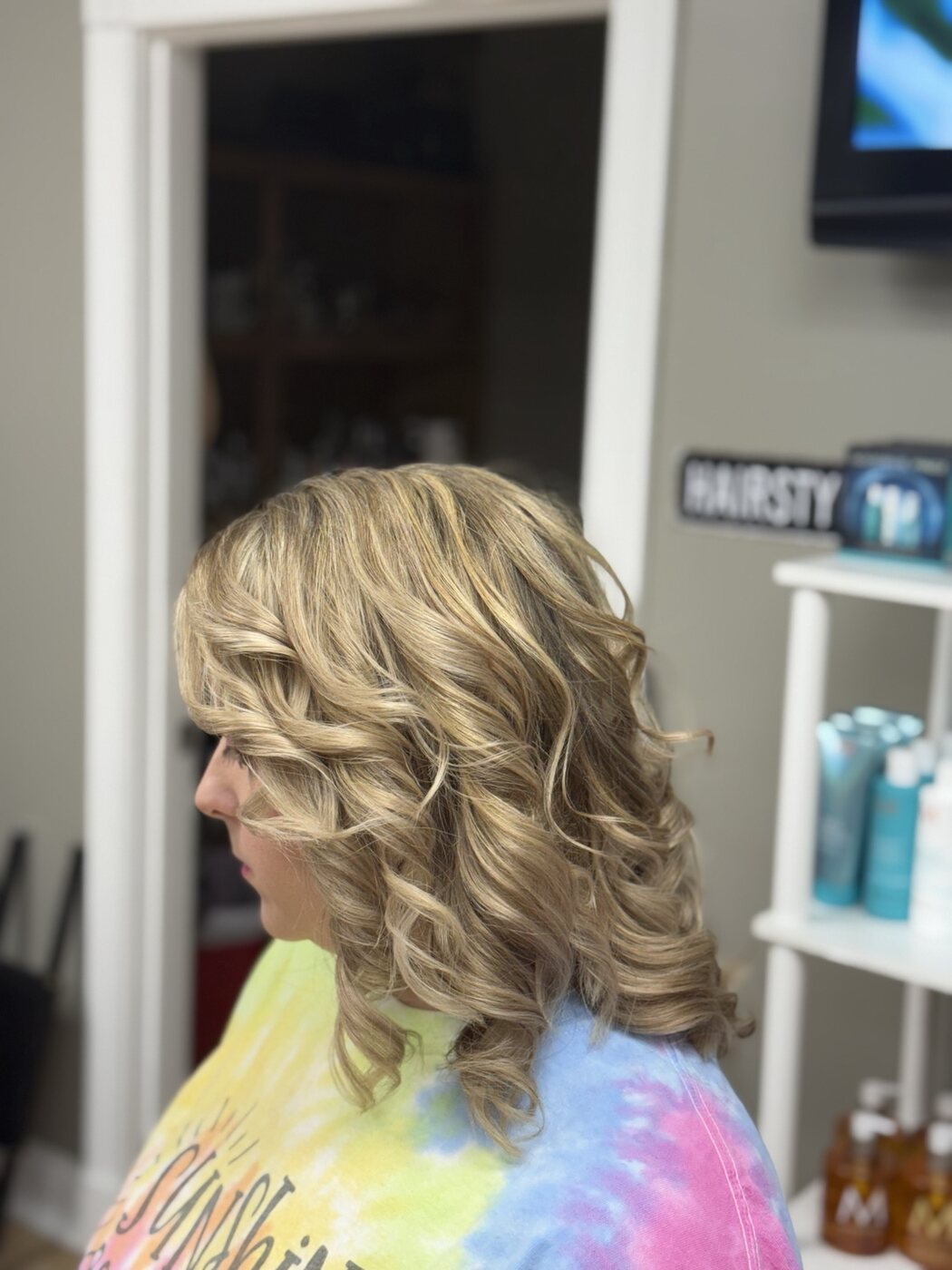 Blonde bob styled in soft polished curls