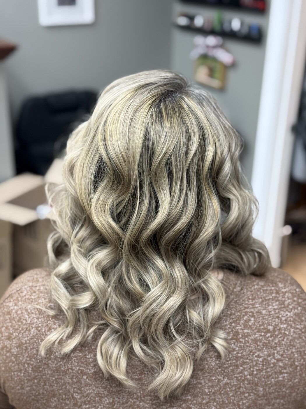 Blonde color with dimensional lowlights and curls