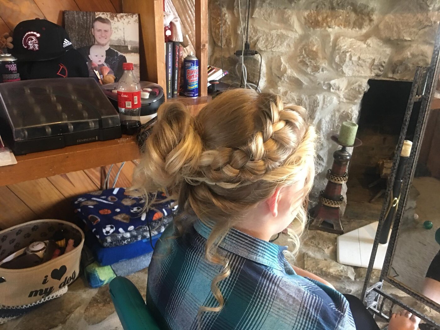 Intricate braided blonde updo with curled tendrils