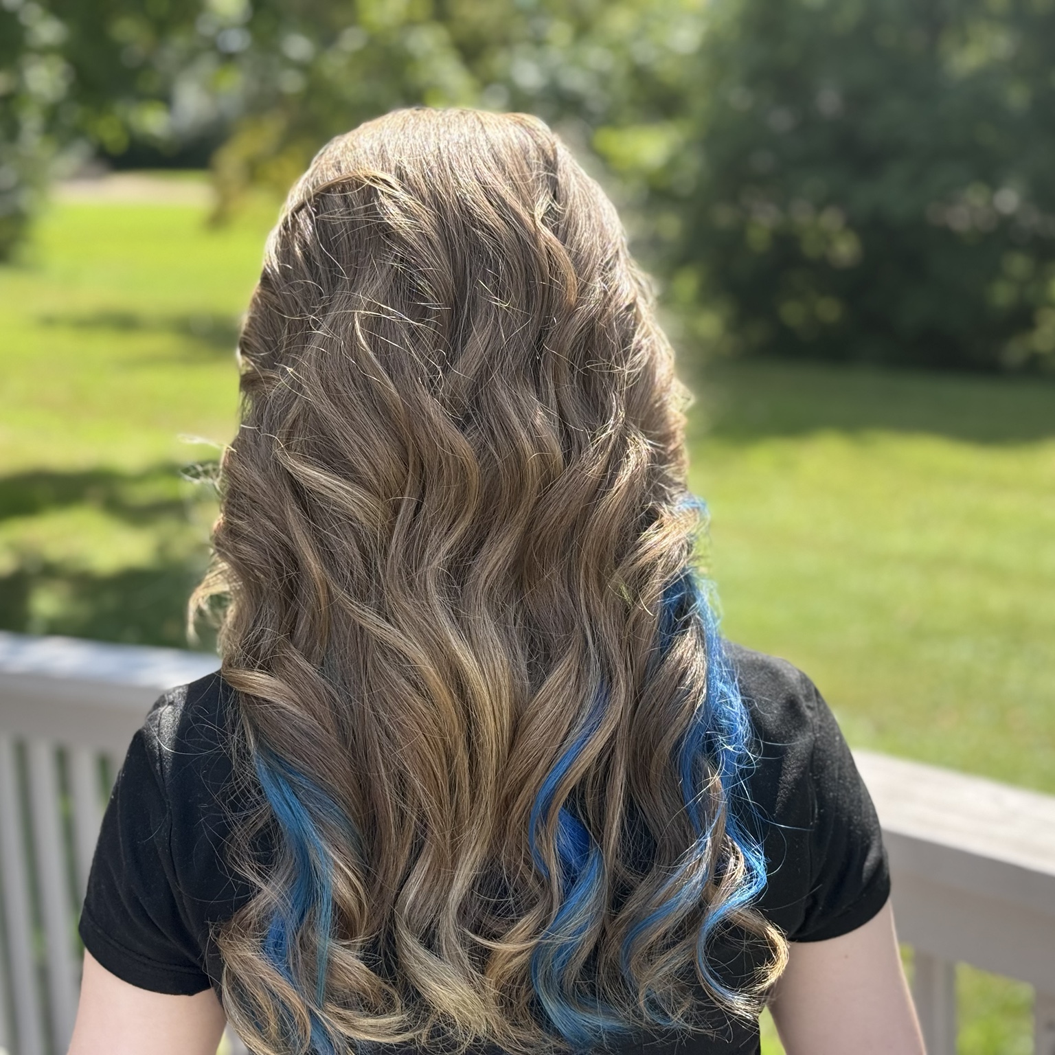 Long dimensional brunette waves with vivid blue accent pieces