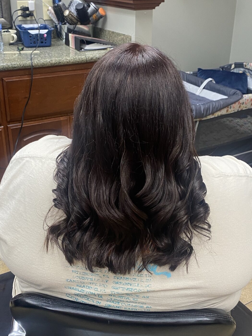 Long brunette hair finished in polished curls