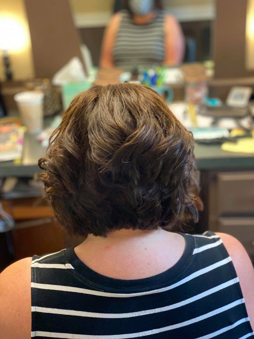Brunette bob styled with soft volume and curl