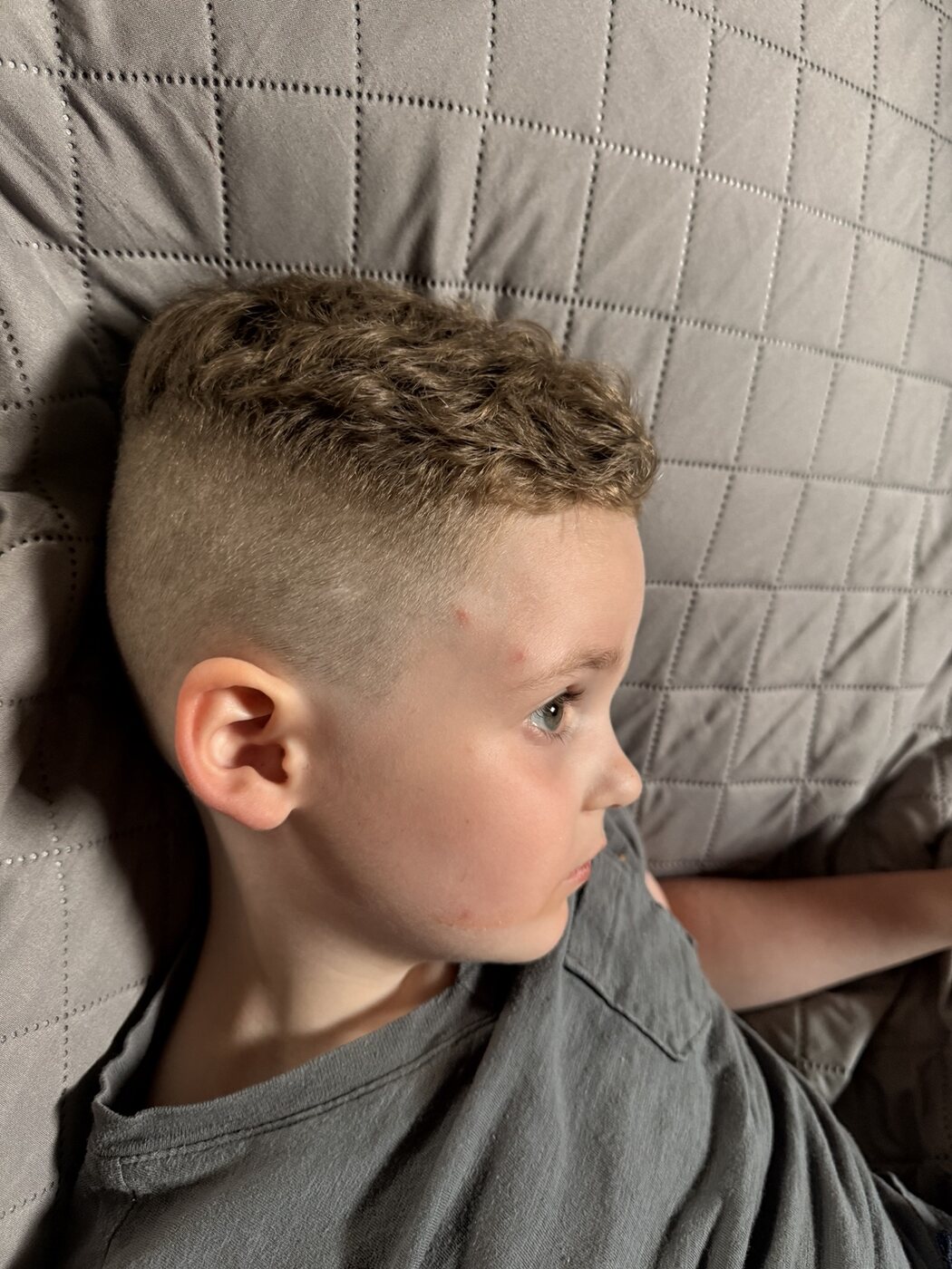 Child's haircut with a clean blended side fade