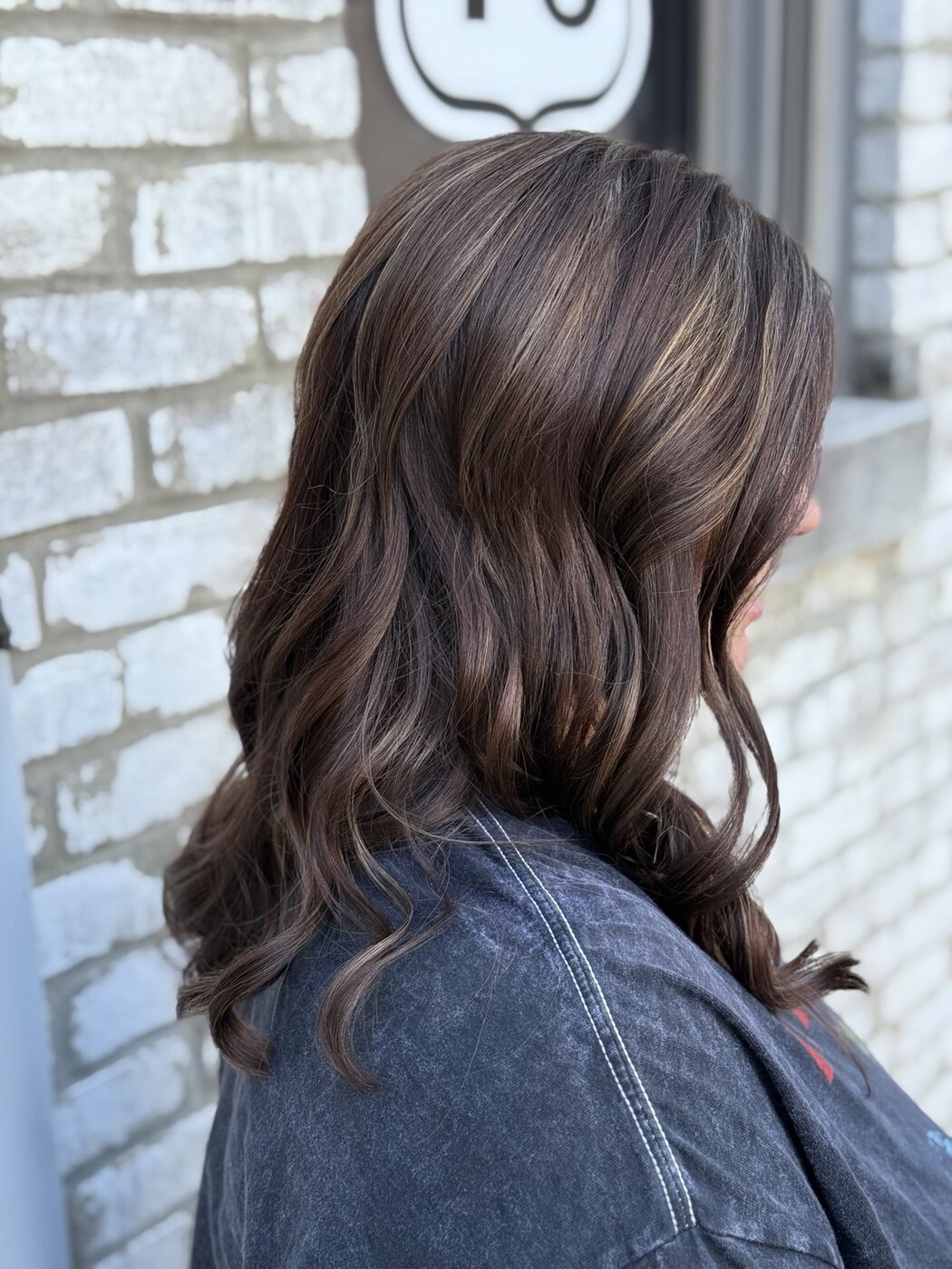 Rich chocolate brunette color styled in soft waves