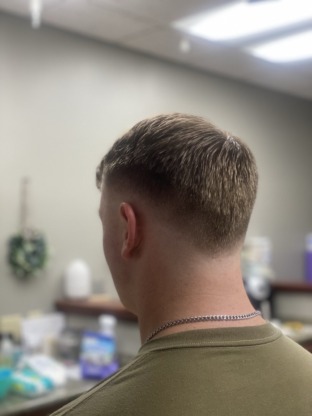 Men's short haircut with a clean tapered back