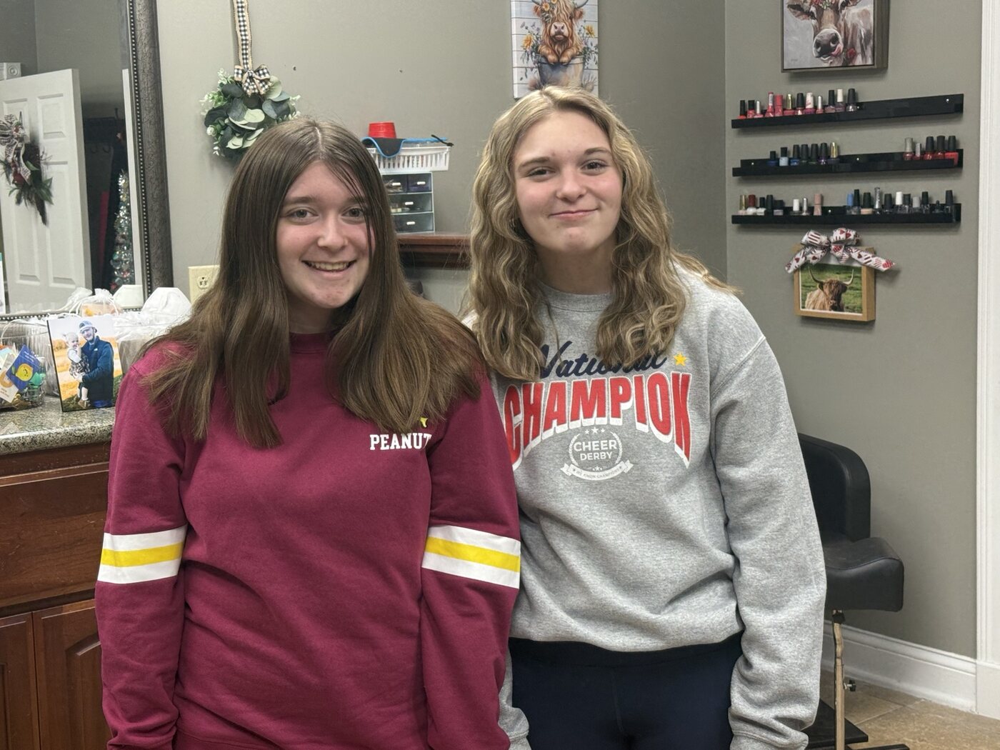 Two clients showing long straight and curled hairstyles