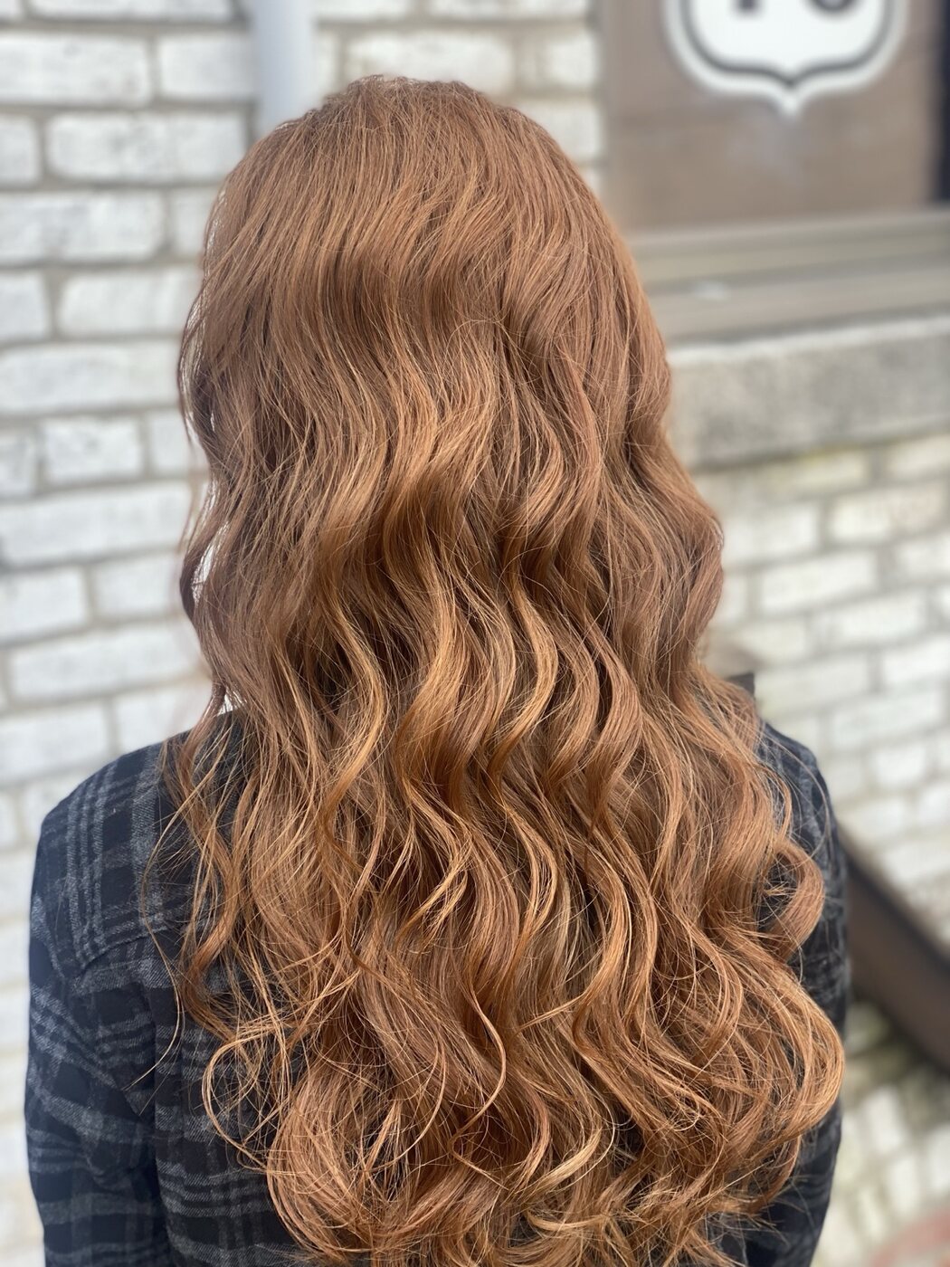 Long copper hair finished in glossy waves