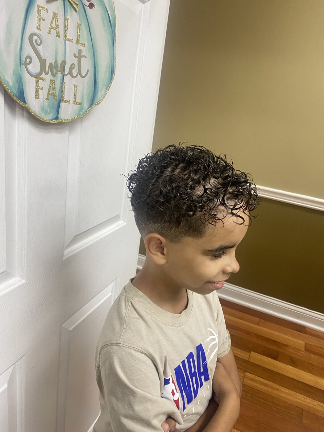 Youth fade haircut with defined natural curls
