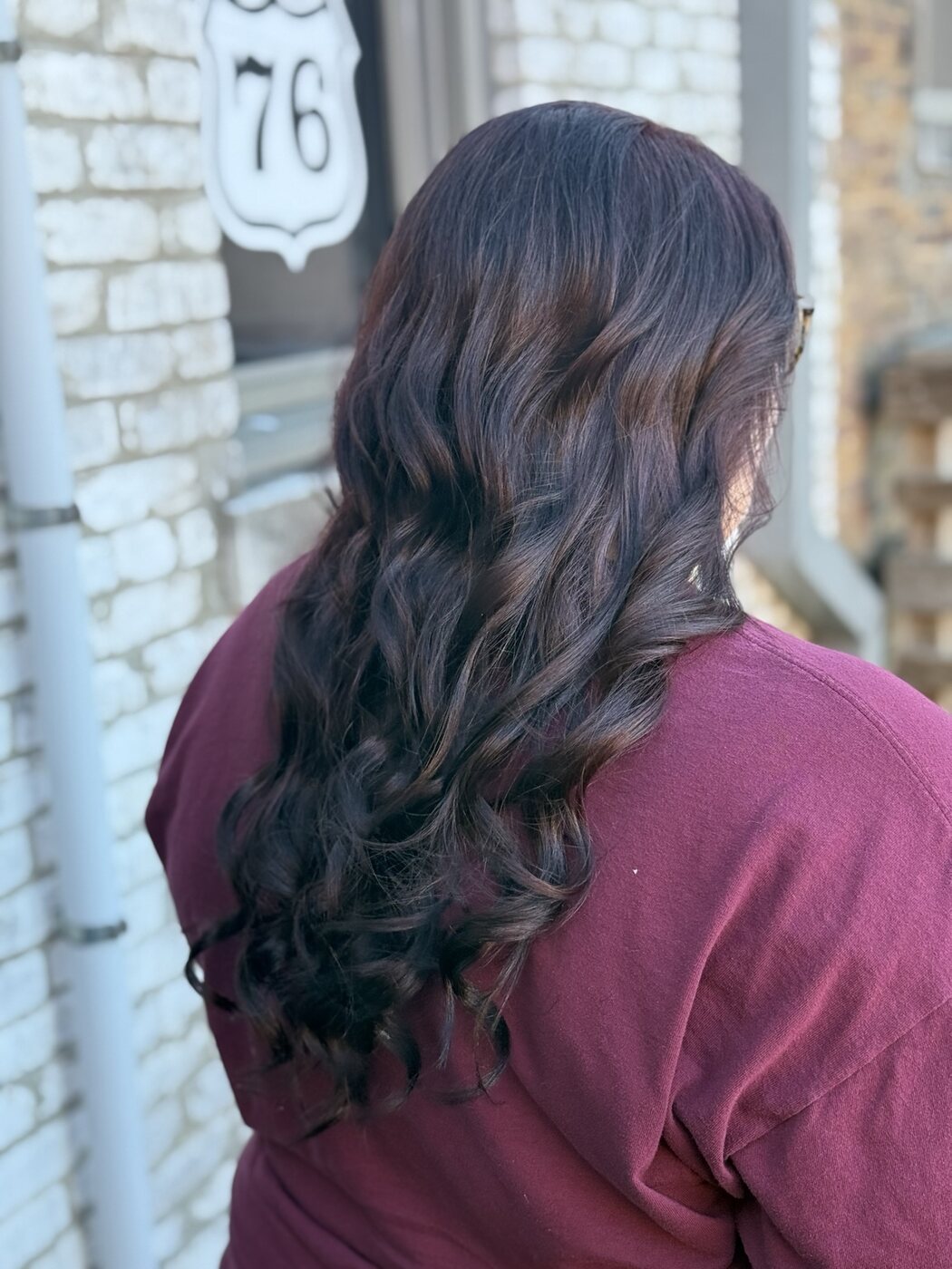 Dark auburn dimensional color styled in long waves