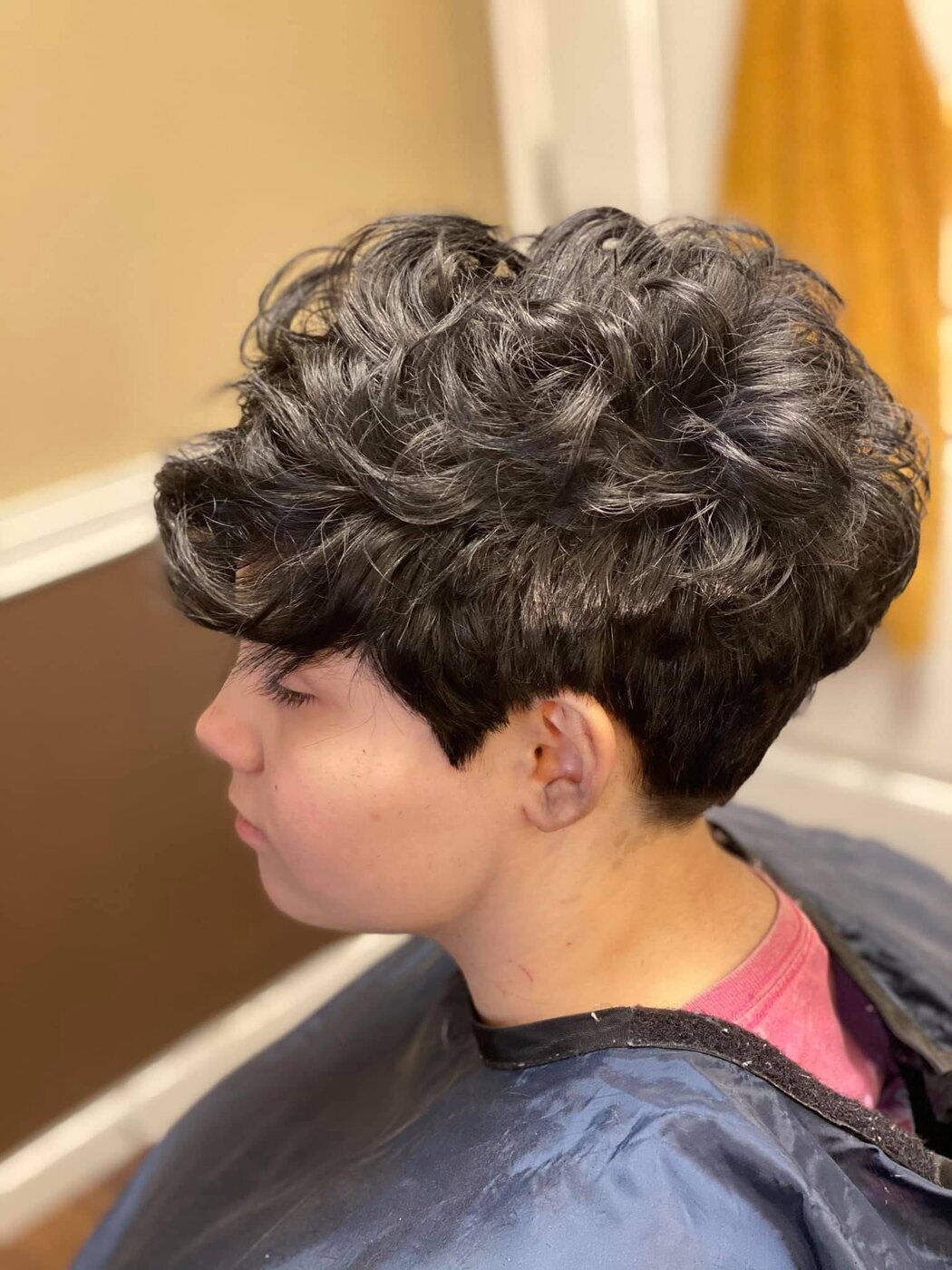 Dark textured pixie cut with a close side