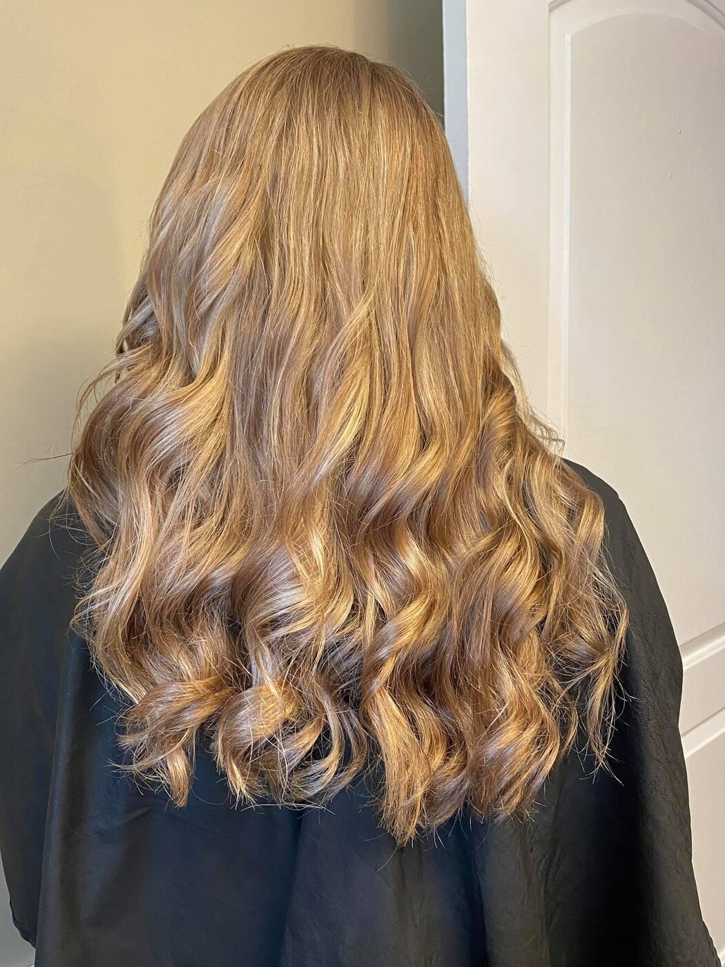 Golden blonde highlights finished in loose curls