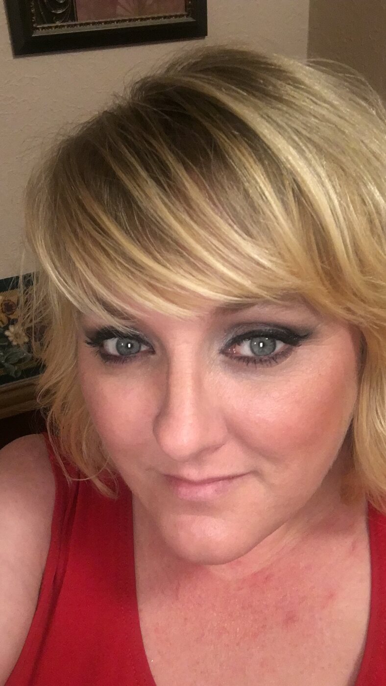 Layered blonde haircut with side-swept fringe