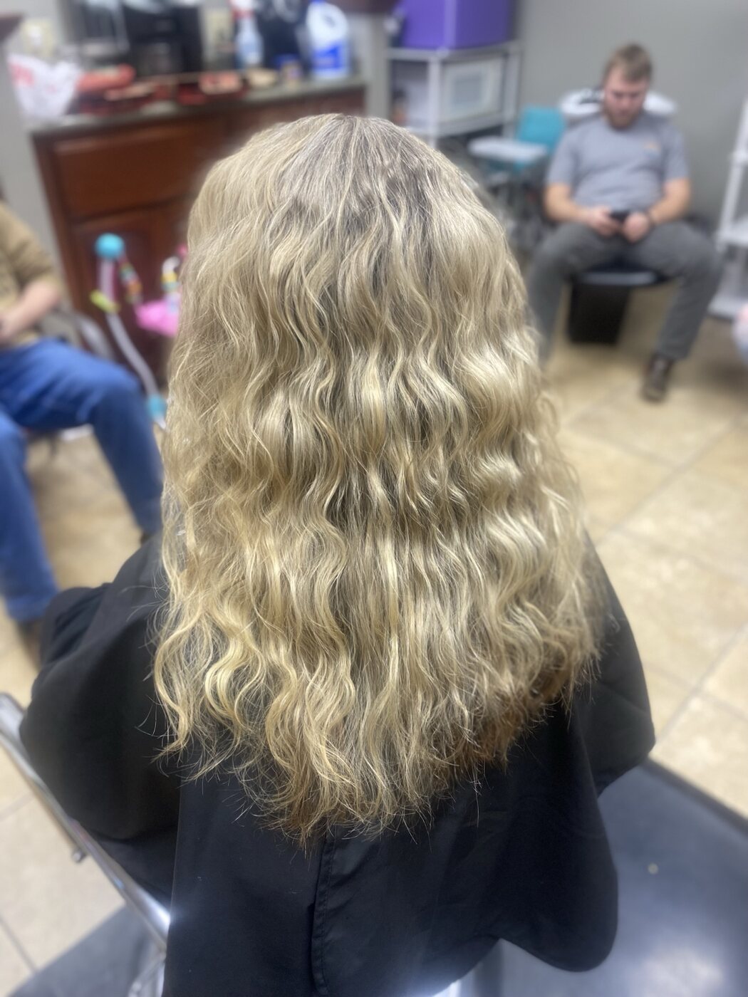 Long blonde hair finished in soft defined waves