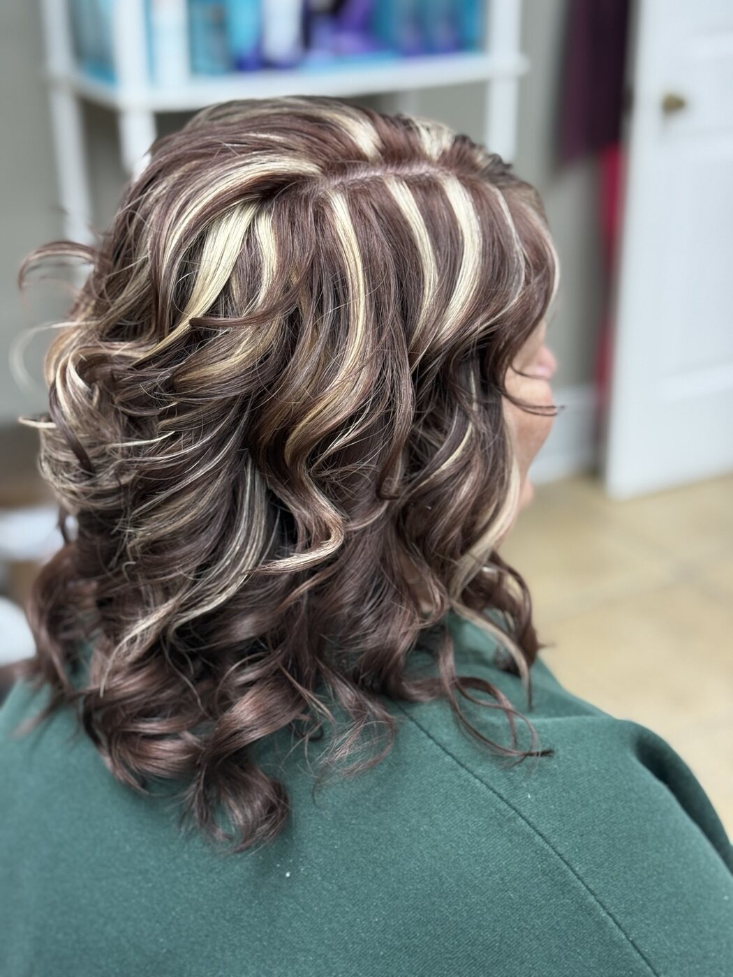 Multi-tonal highlights styled in dimensional curls