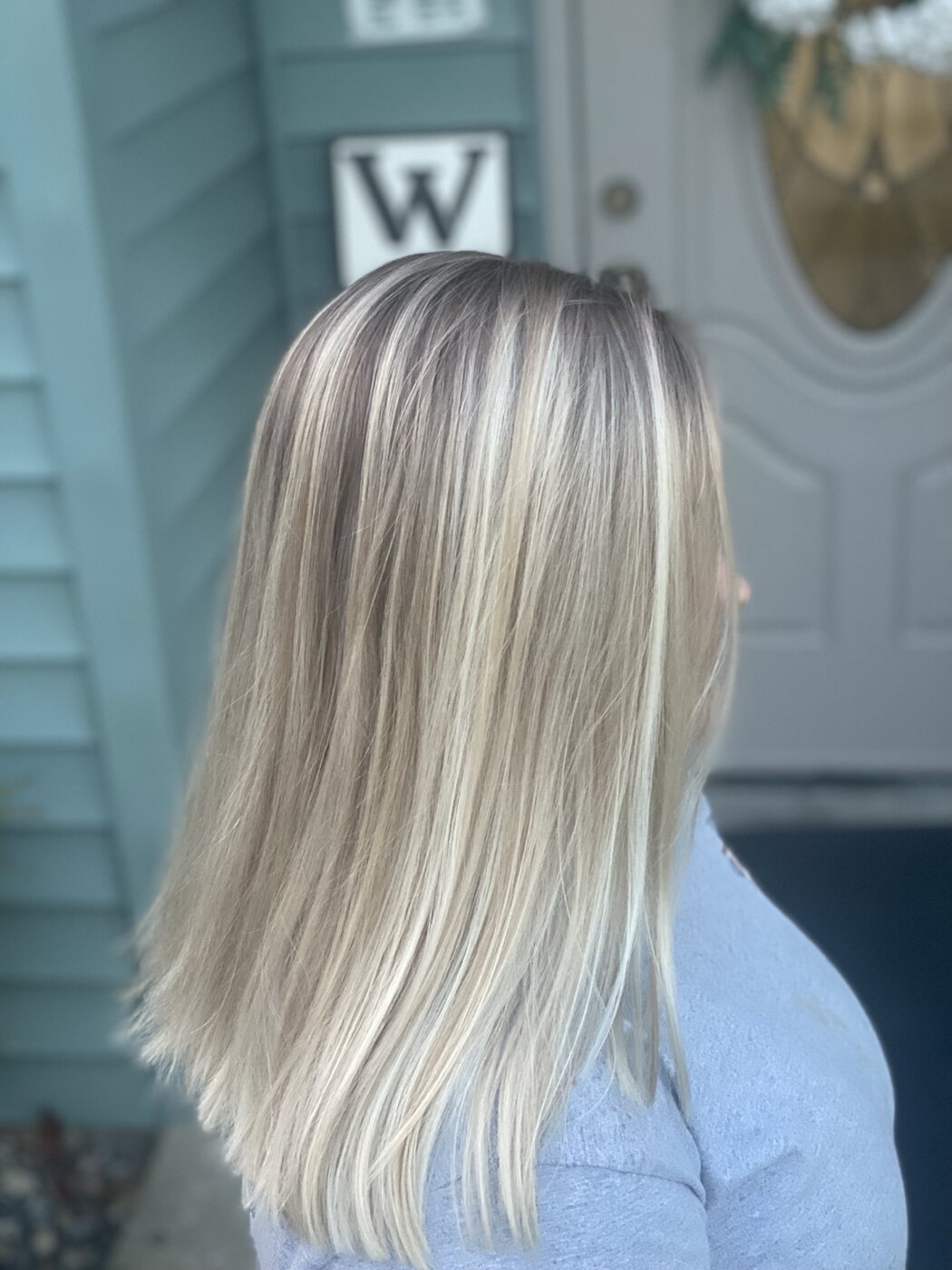 Long platinum blonde highlights with a smooth finish