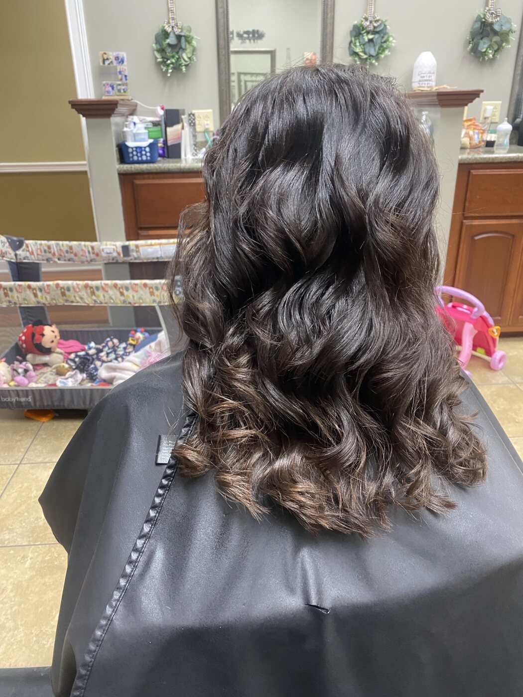 Rich brunette color finished in glossy curls