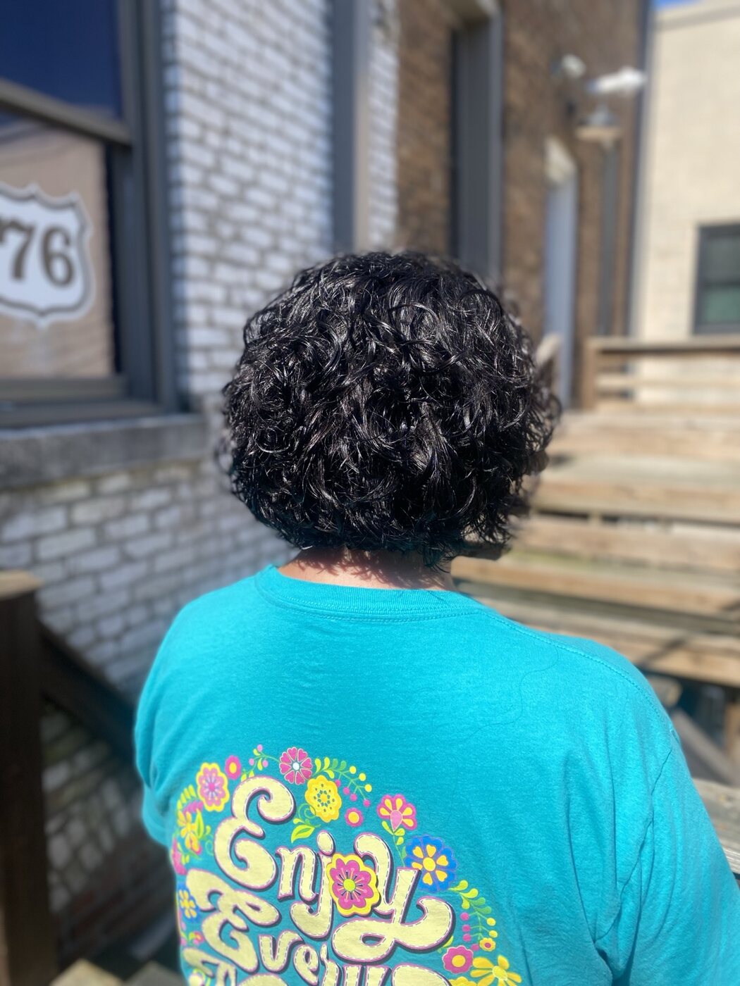 Short dark hair styled in defined curls