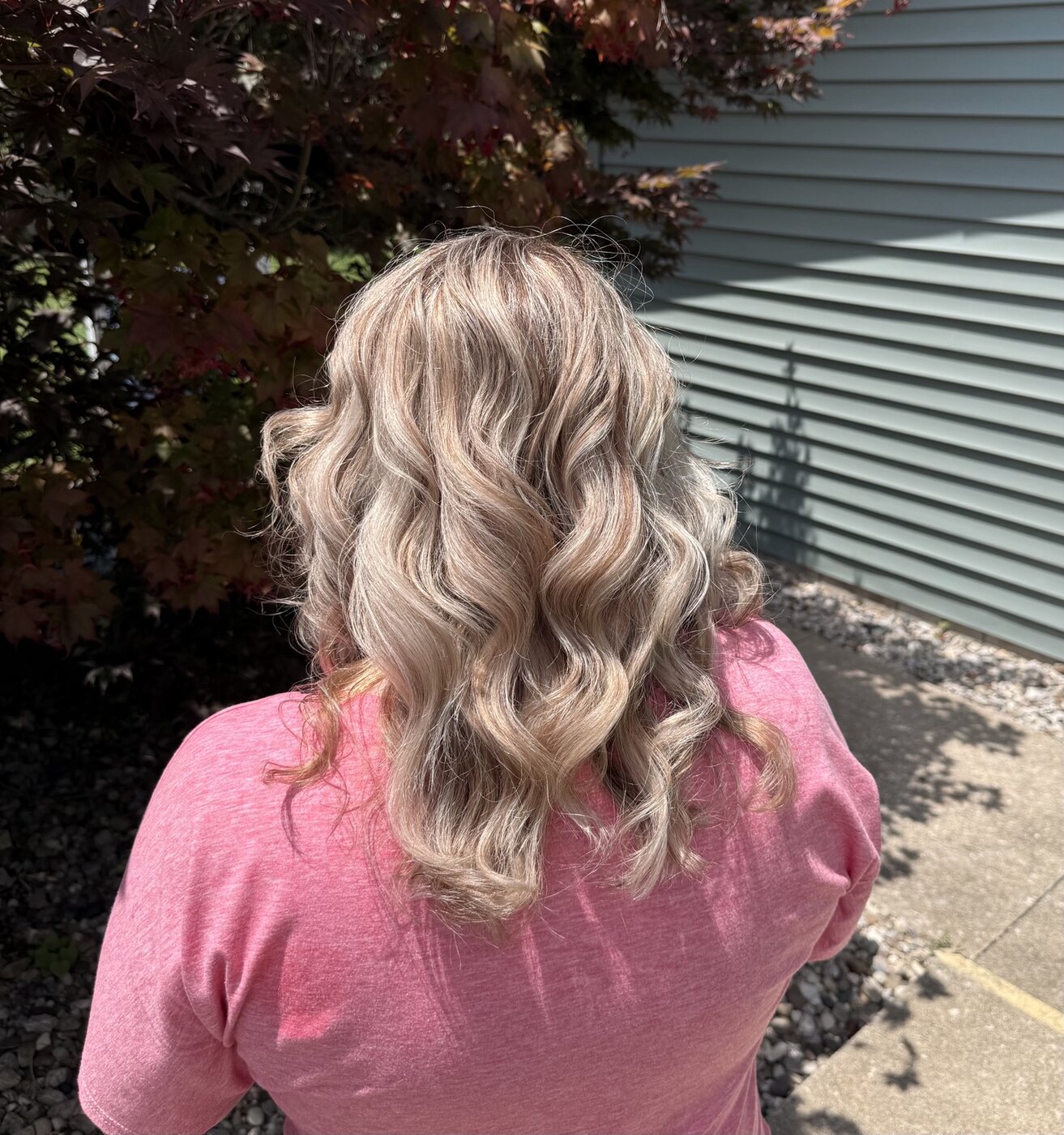 Silver-beige blonde color styled in soft curls