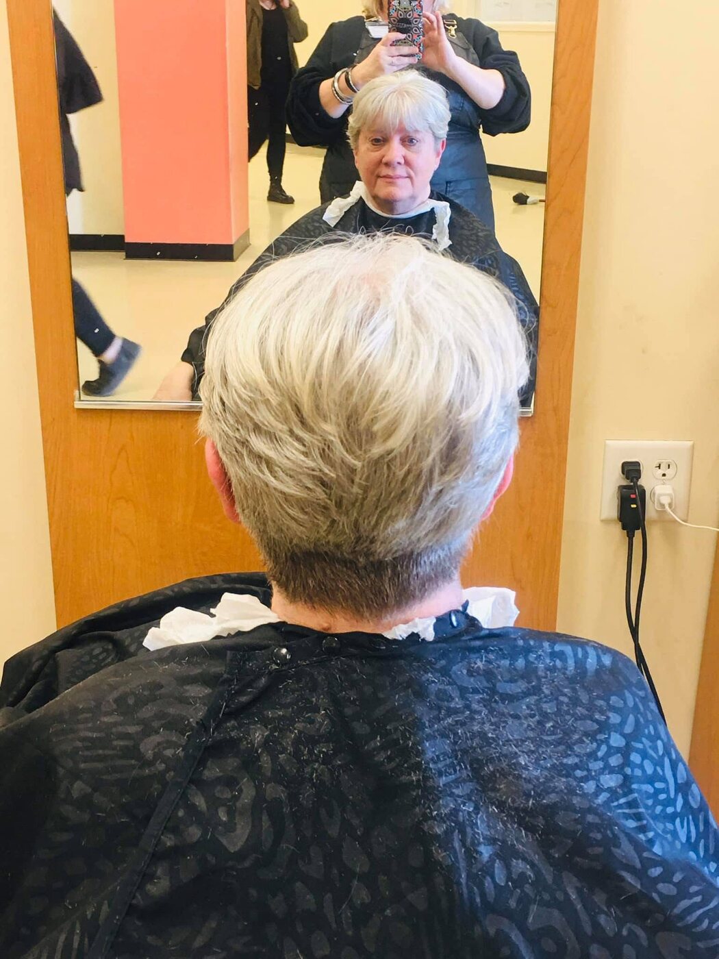 Short silver pixie cut with a softly tapered back