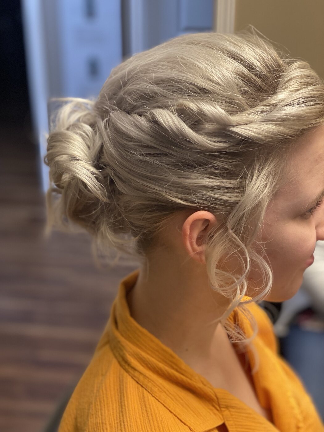 Silver formal updo with braided detail and curled tendrils