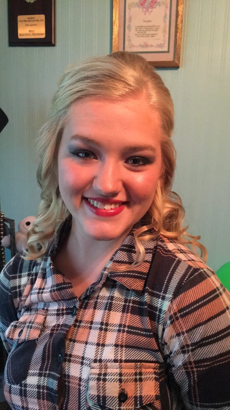 Soft blonde curls styled for a polished occasion look