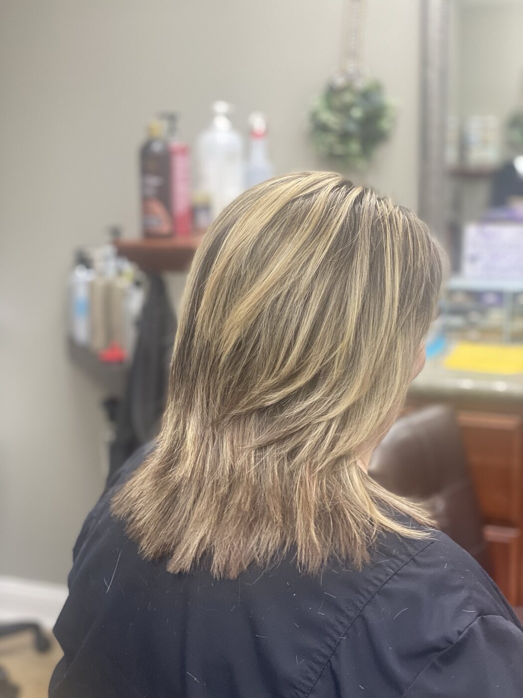 Textured blonde highlight service with soft layered ends