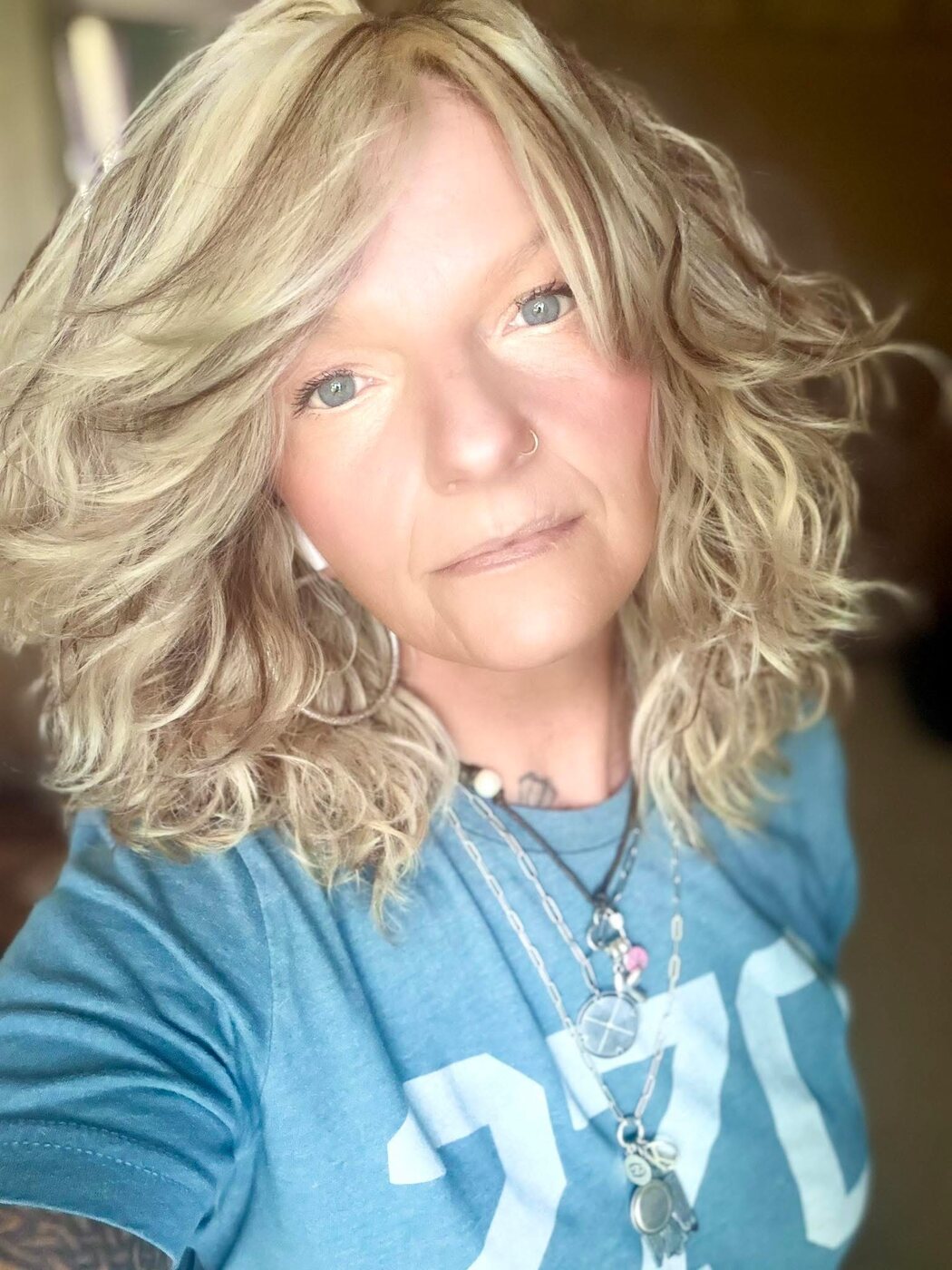 Blonde hair styled with voluminous curls and layers