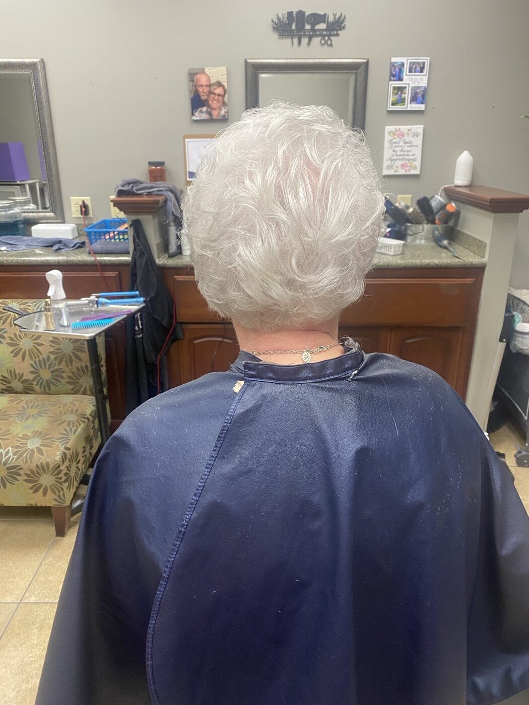 Short white hair shaped into soft curls