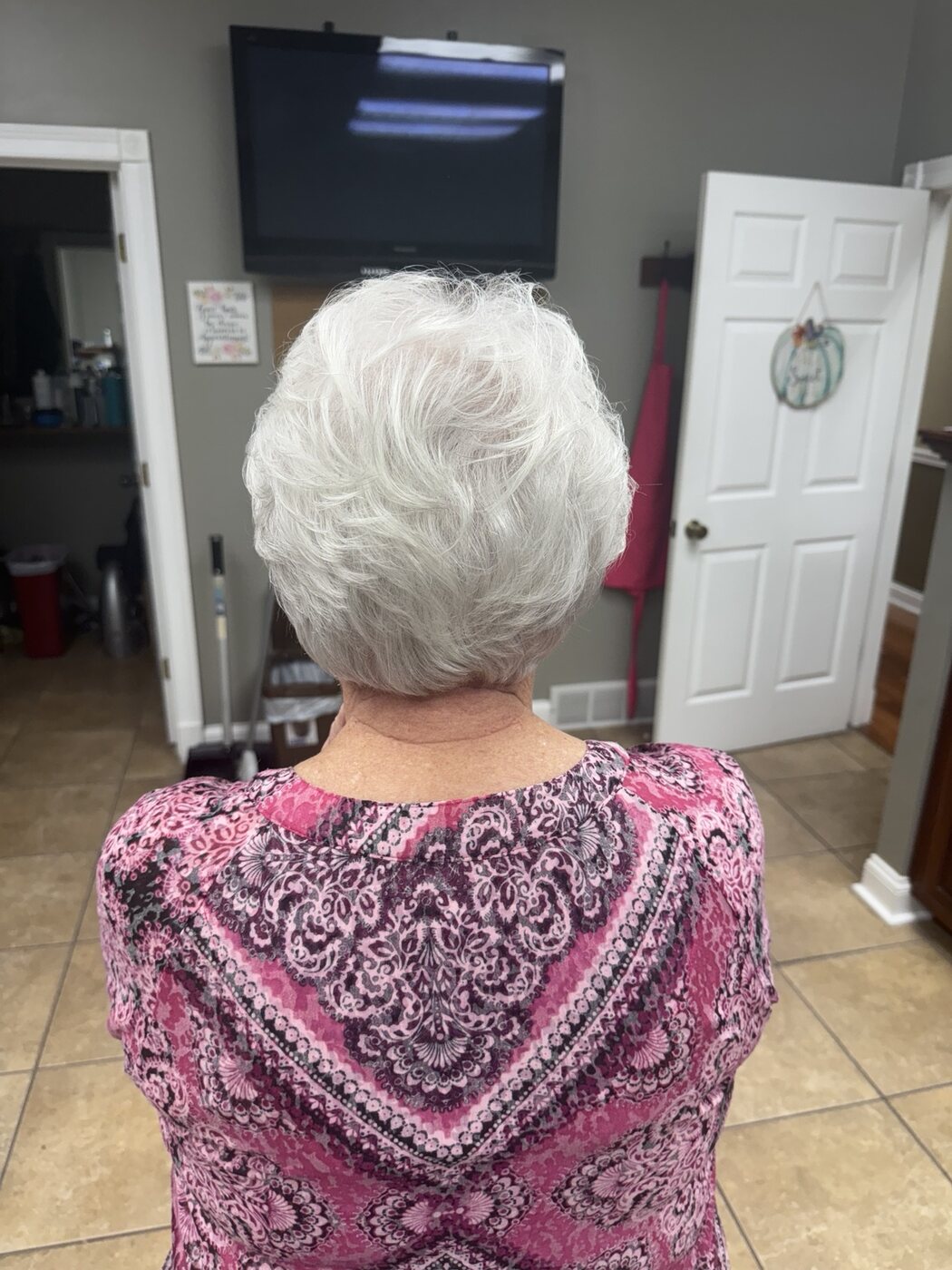 Softly shaped white pixie cut viewed from the back