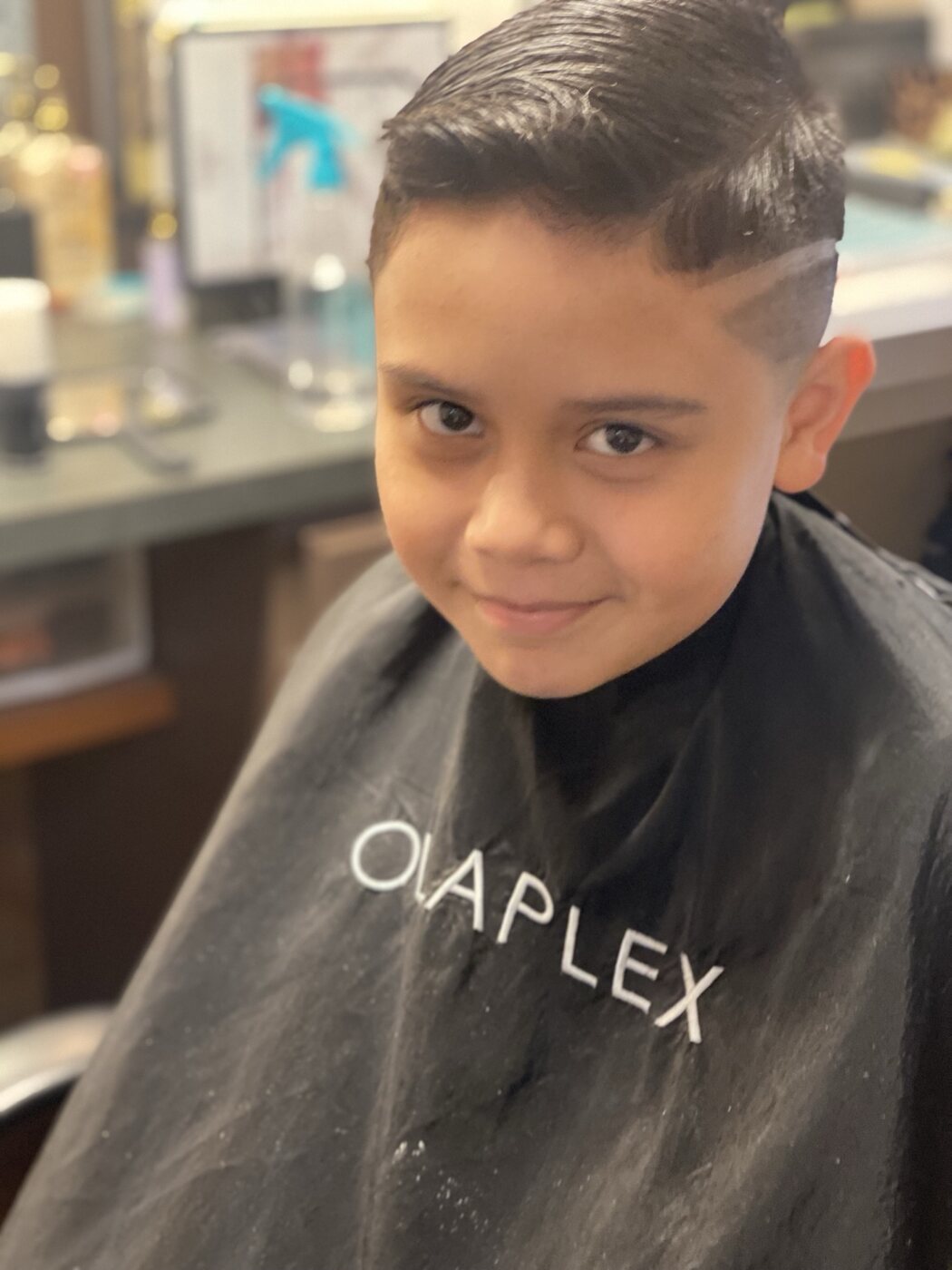 Clean youth fade haircut with a textured top